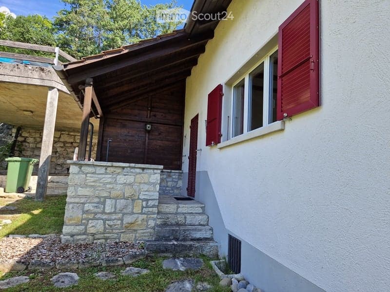 front of the house, stone steps, red shutters, white exterior, brown wooden structure