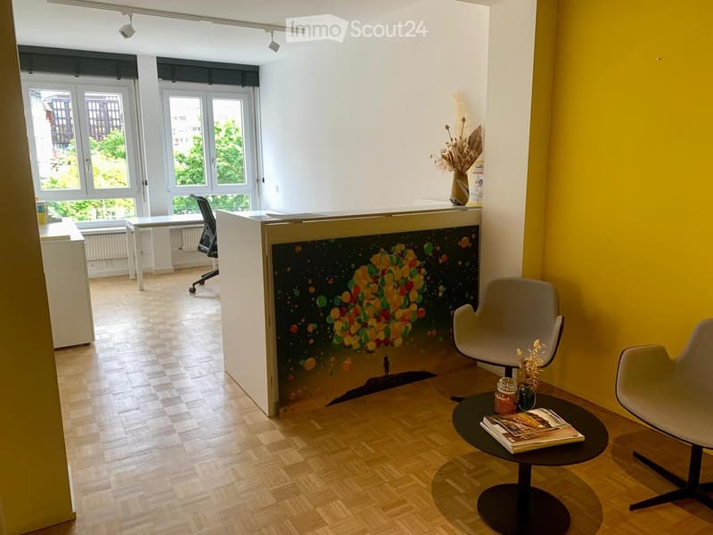 office room with wooden floor, wall art, desk, office chair, windows