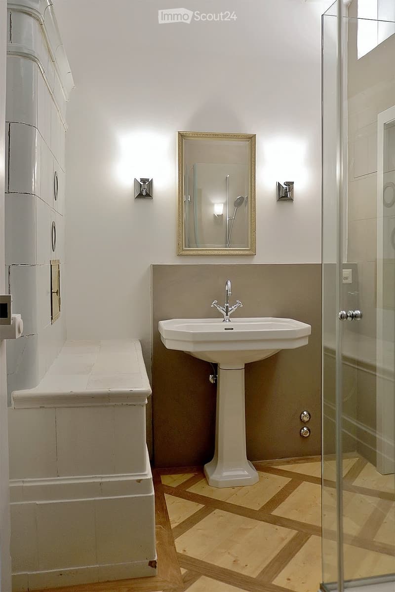 white sink, shower stall, mirror, lights