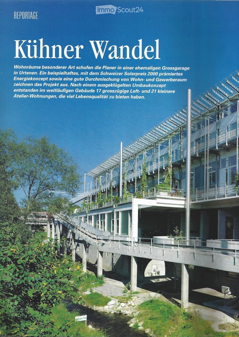 Multi-story residential building, solar panels on the roof, balconies with plants, bridge connecting the building to the ground