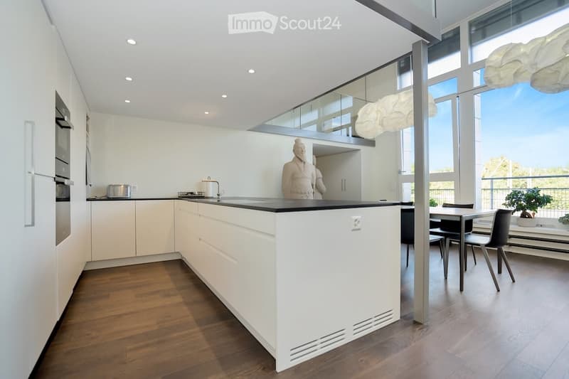 modern kitchen with open shelves, black granite countertop, white cabinets, stainless steel appliances, large windows, and a dining area