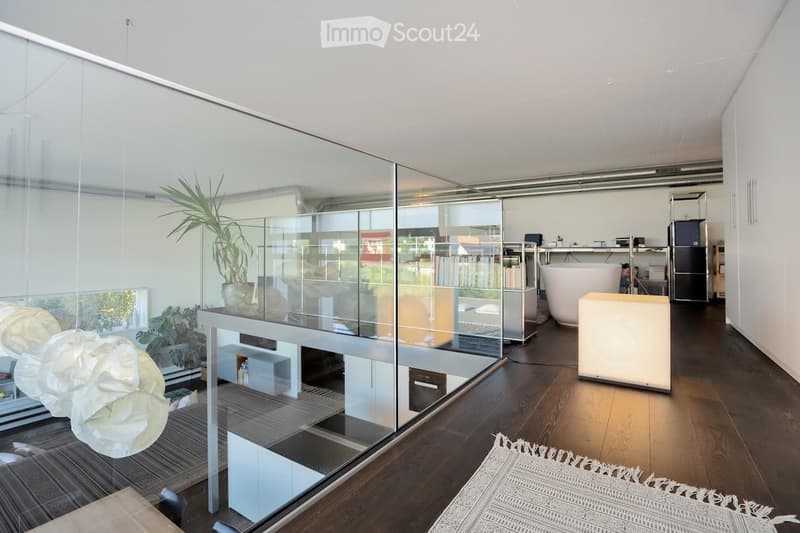 room with glass walls and balcony, hardwood floors, modern furnishings