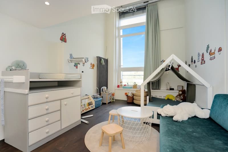 a children's room with a stack bed, desk, play area, round table and stool, and a play tent