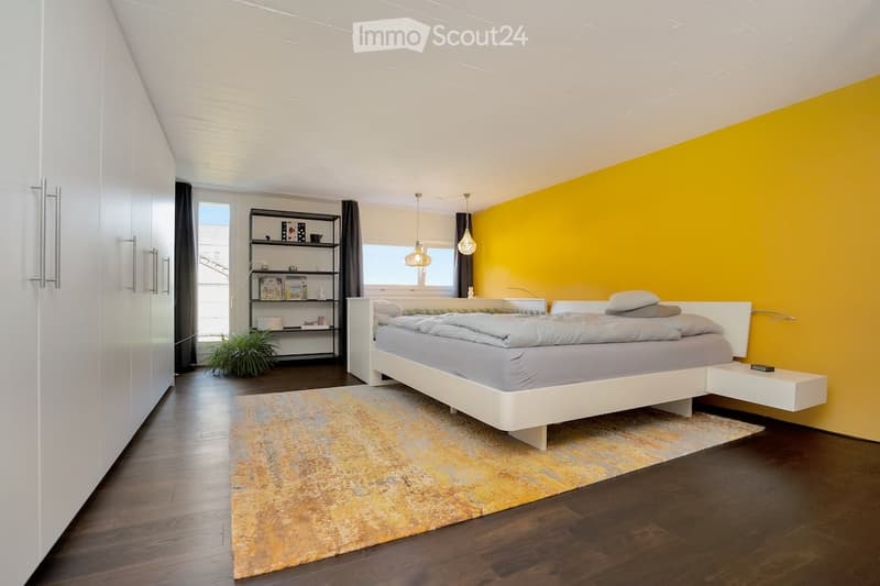 yellow wall, dark wooden floor, gray bedding, shelf, modern decor