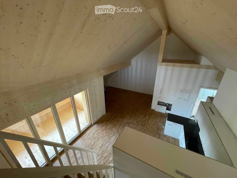 steep attic space, wooden ceiling, wooden floor, white walls, open windows, stairs