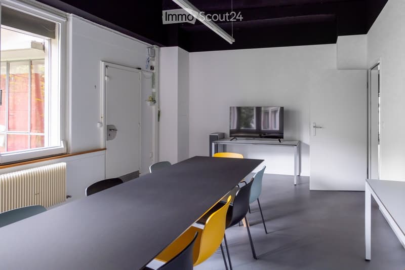 conference room, large table, chairs, television on stand, radiator, doors