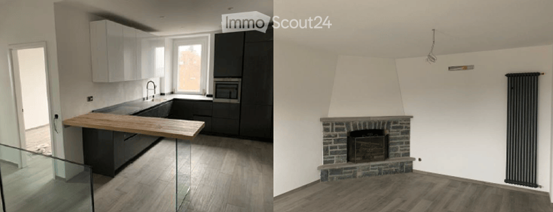 Open-plan kitchen with modern wooden countertop, glass railing, fireplace in another room, white ceiling, modern appliances