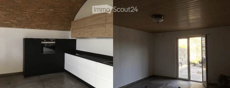 Contemporary kitchen and empty room with an open door.