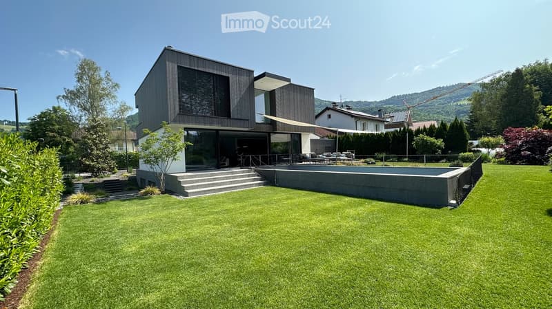 modern 2 story house, black exterior, glass windows, gray pool, large steps, garden
