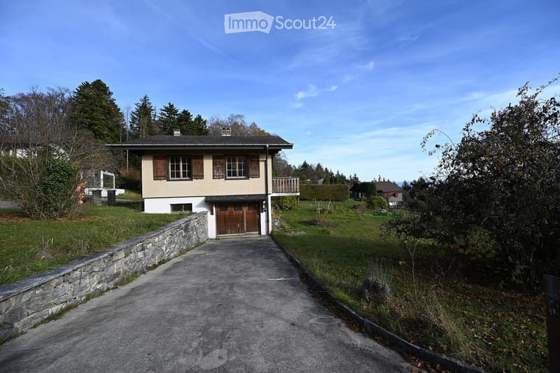 2 story house, brick, brown door, driveway, stone wall, yard, balcony