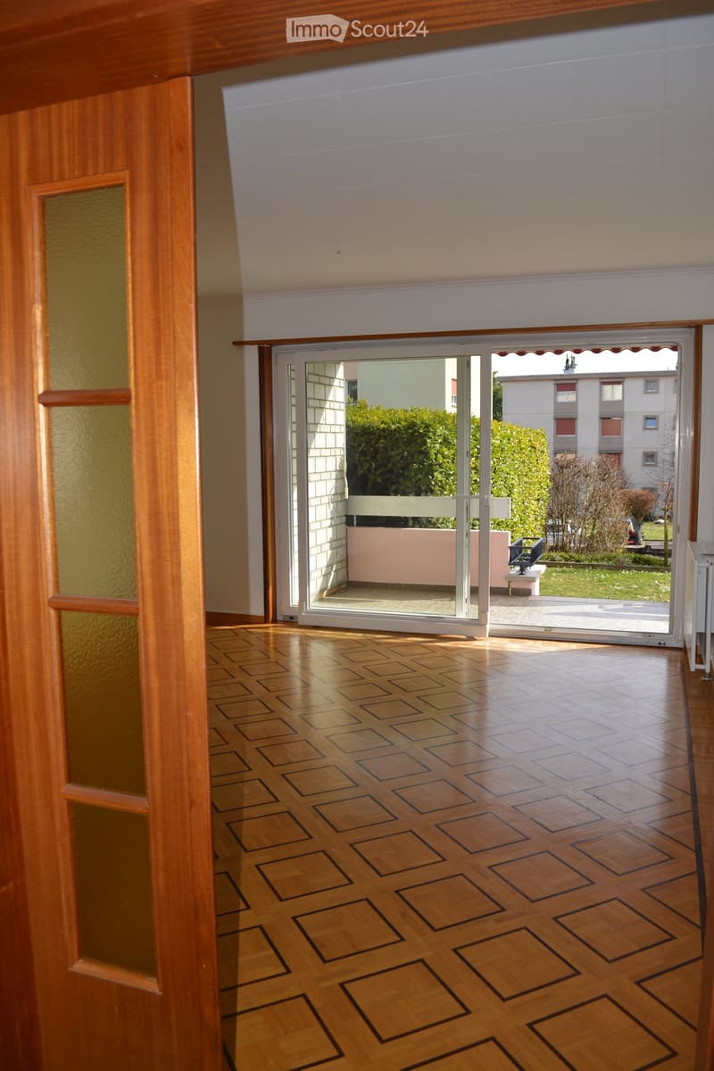 Empty room with sliding glass doors leading to a balcony