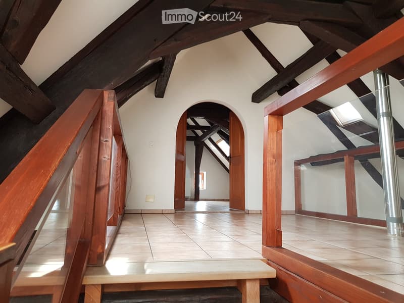 attic room, wooden ceiling, tiled floor, glass railings, doorways, skylights
