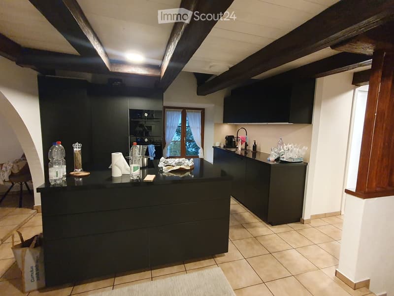 kitchen with island, cabinets, drawers, tiled floor, ceiling beams, window, oven