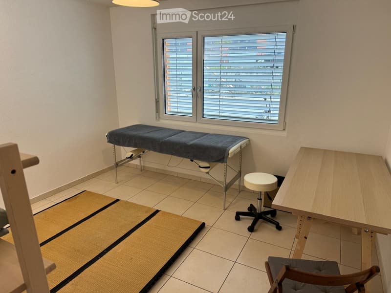 furniture for treatment, white walls, window with blinds, floor in tiles, desk, stool, wooden chair, mat