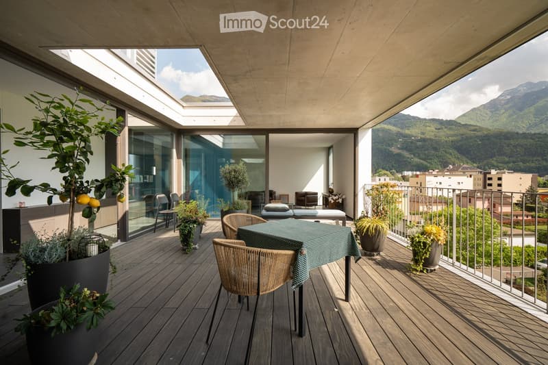 wooden deck, table, chairs, plants, railing, mountain view