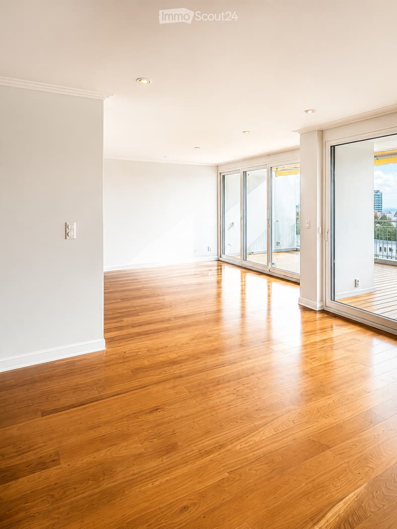 Unfurnished Room. Empty room with wooden flooring, white walls, and large glass sliding doors leading to a balcony.