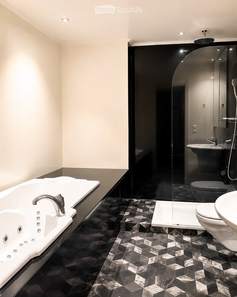 Bathroom. Modern bathroom with a white bathtub, black tiled floor, and a glass-enclosed shower area. Features a toilet, sink, and a sleek faucet.