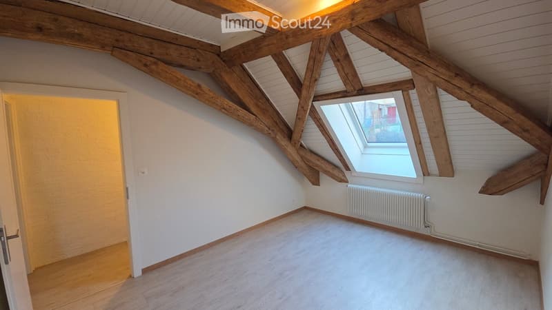 empty room, white walls, wooden beams, wooden floor, window with white frame