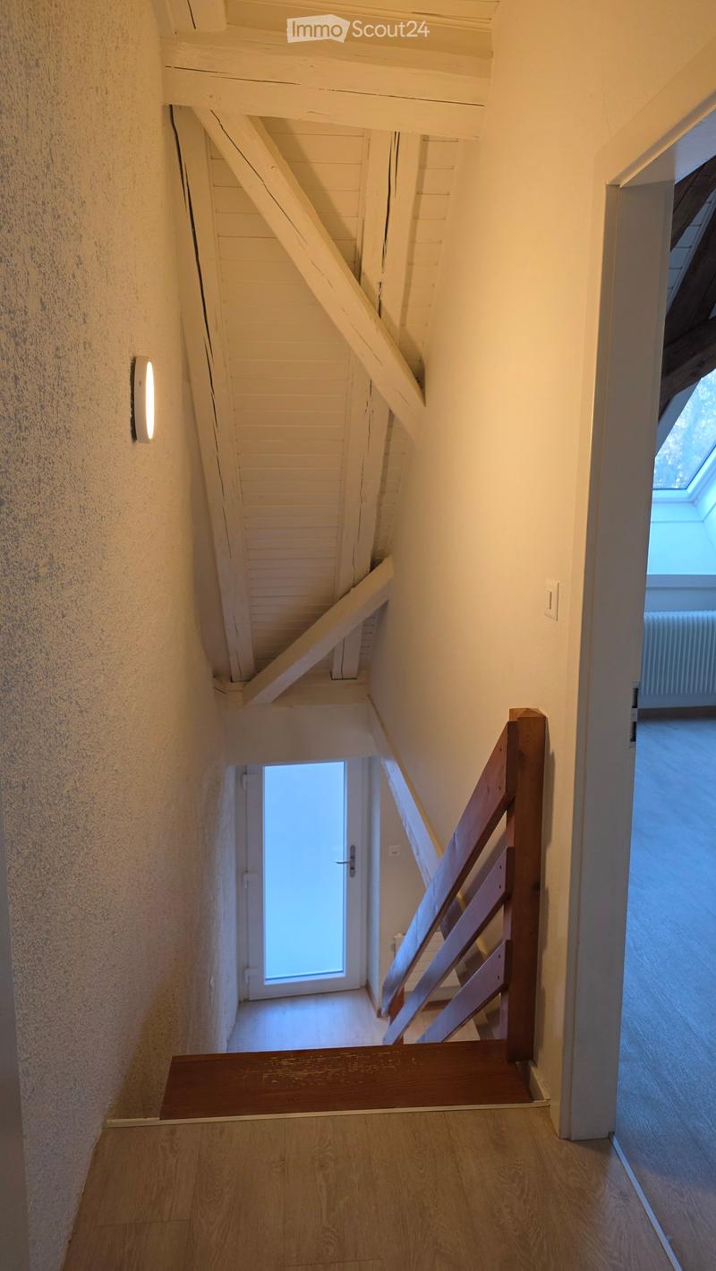 interior wooden staircase, wooden railing, wooden handrail, slanted ceiling