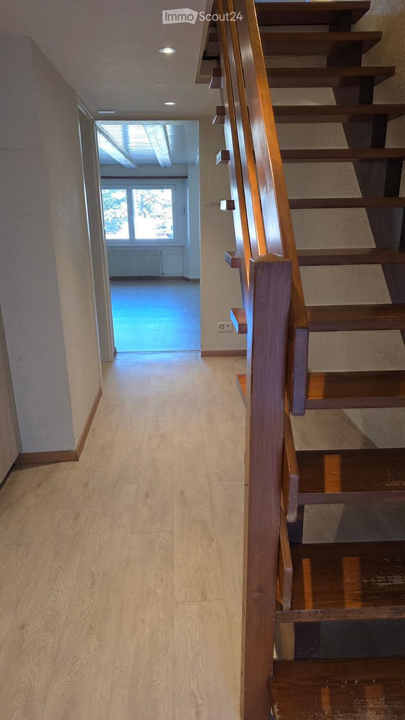 wooden staircase, wooden flooring, ceiling lights, open room with windows and radiator, hallway