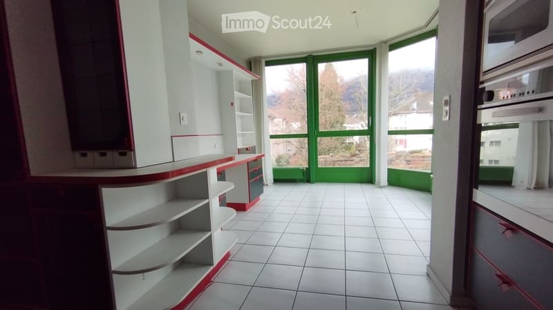 empty kitchen with white tiles, cabinets, shelves, large windows