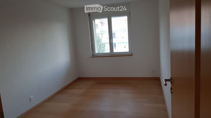 empty room, wooden floor, white walls, window with view