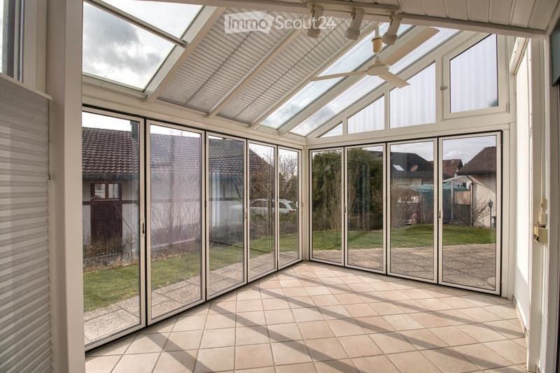 glass walls, tiled floor, large windows, openable glass doors