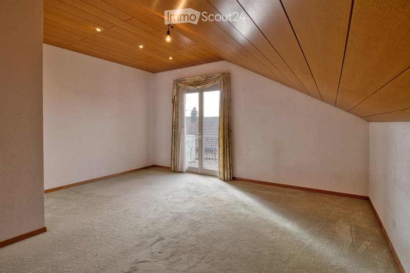 empty room, beige carpet, white walls, wooden ceiling, glass sliding door to balcony