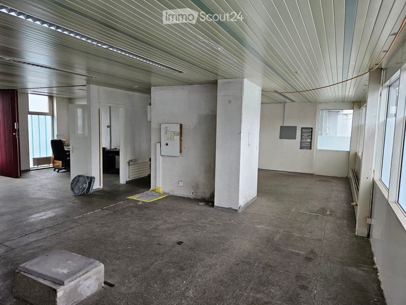 Empty room with white walls, tiled floor, white ceiling, doors, windows, radiator, electrical outlets, and a black chair