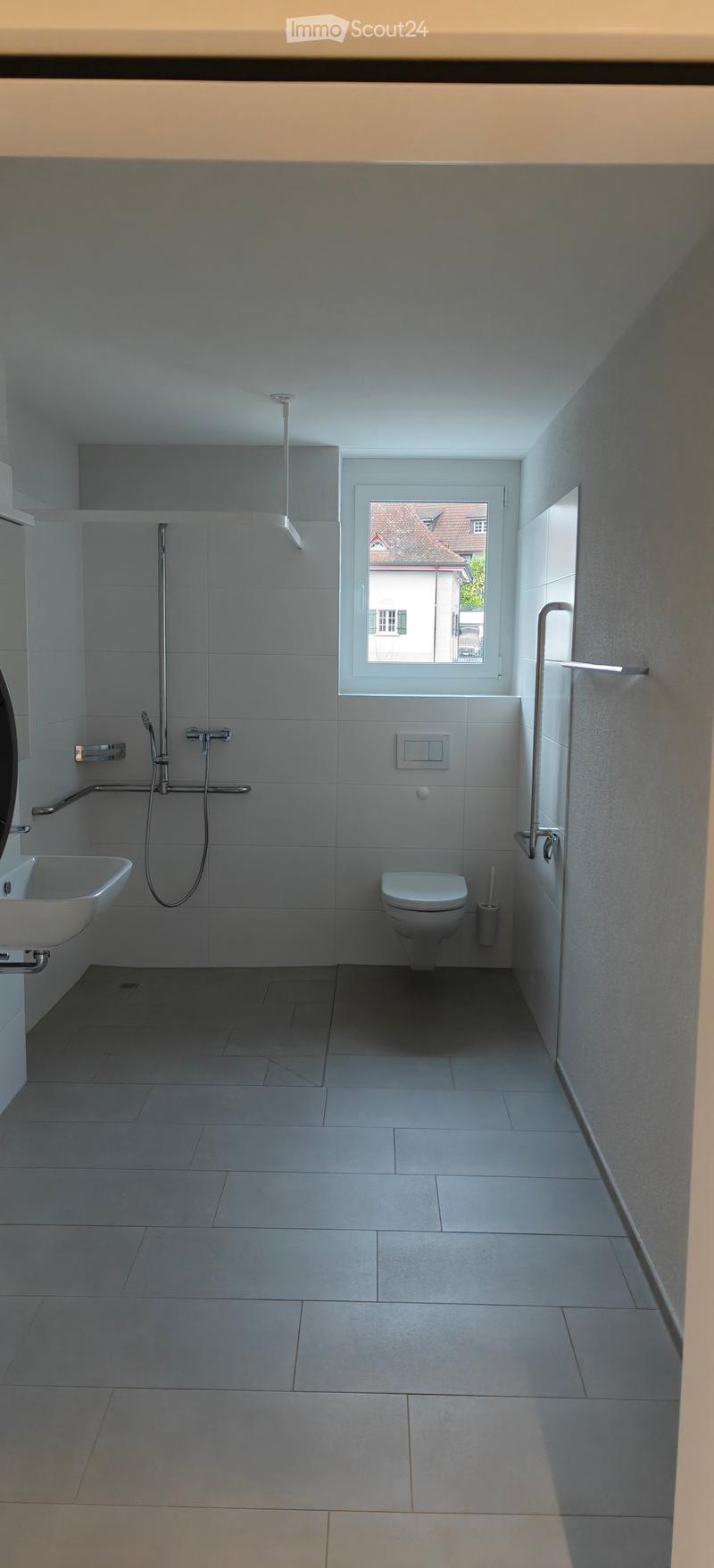 white tiled walls, shower, sink, toilet, window