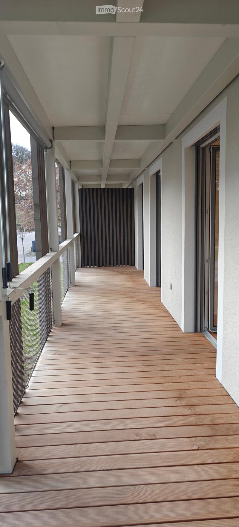 Wooden balcony with railings and windows