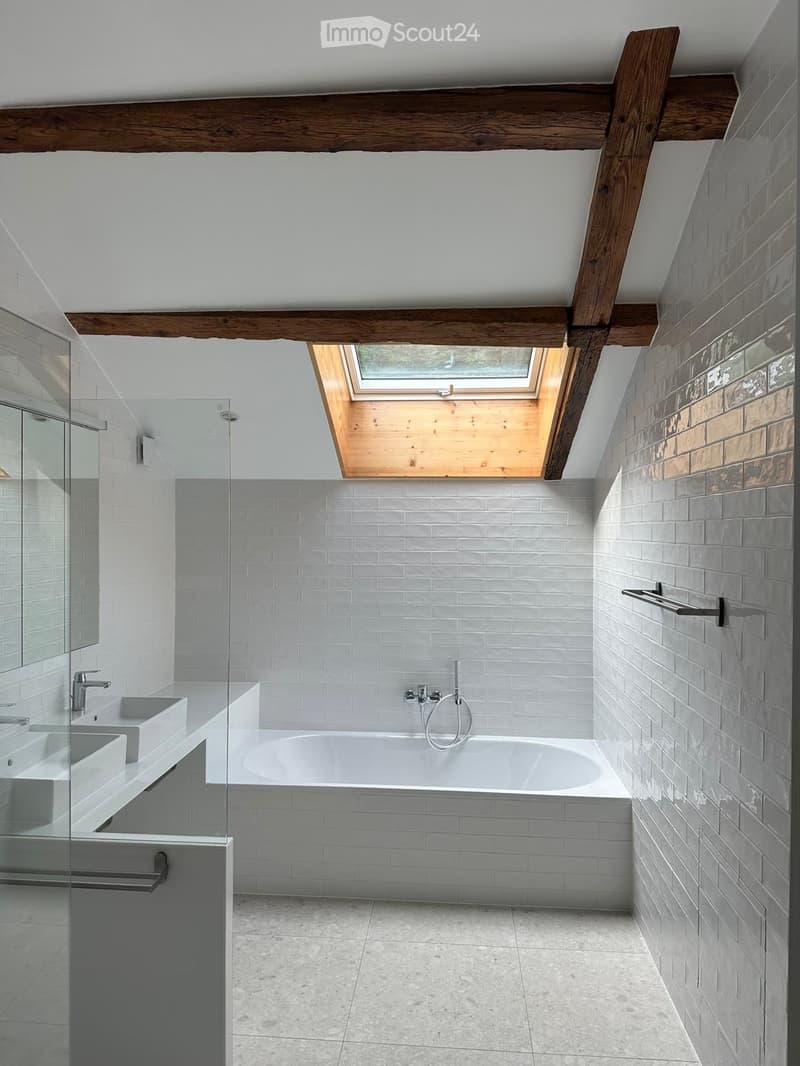 modern bathroom with white tiles, bathtub, shower, sink, mirror, skylight