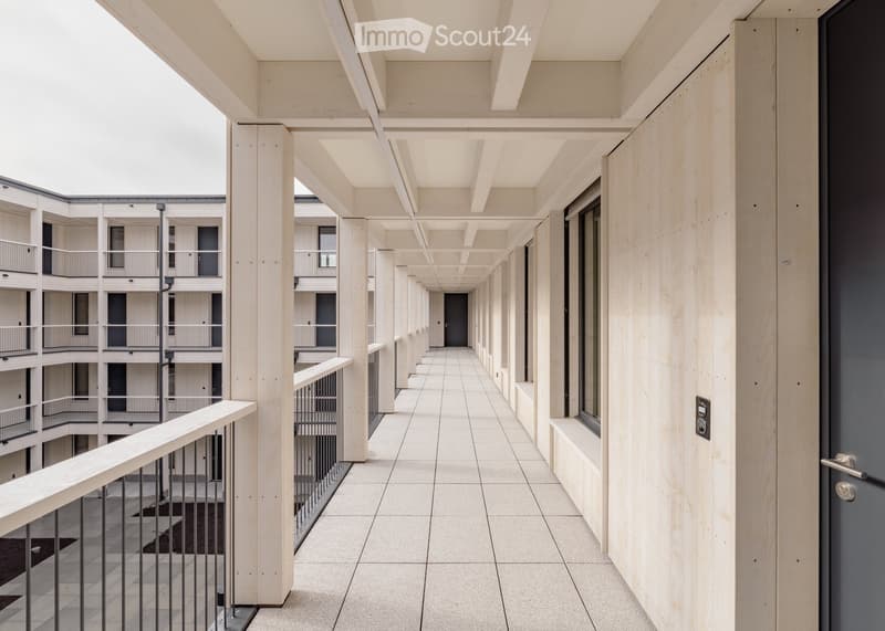 modern building, white walls, wooden beams, tiled floor, balconies, windows