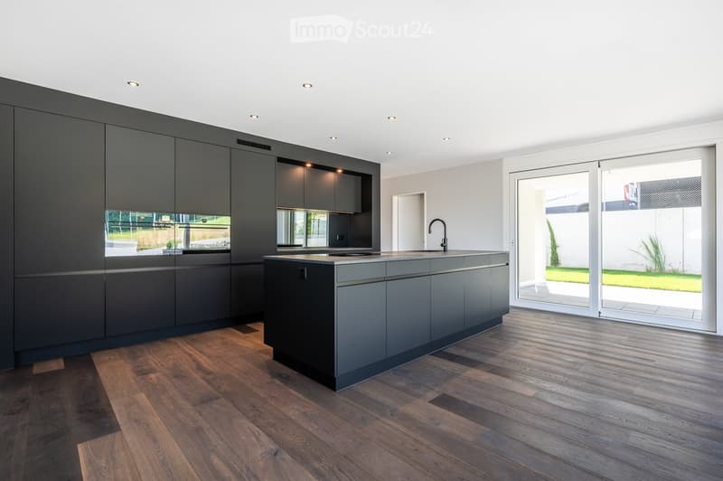 modern kitchen with island, black cabinets, wooden floor, large windows