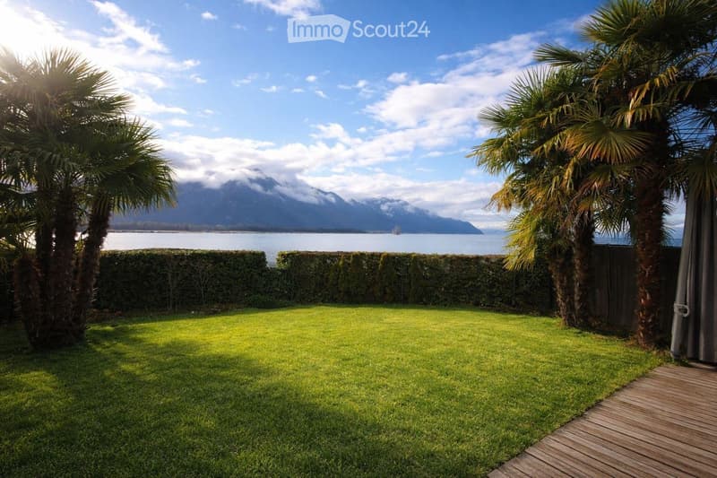 well-maintained lawn, hedges, palm trees, wooden deck, view of the lake and mountains