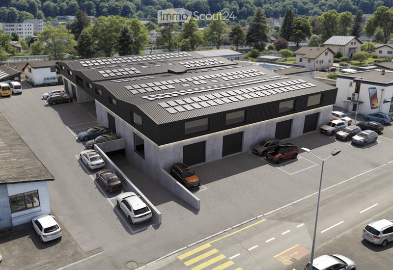 Commercial building with solar panels on the roof, multiple parking spaces, modern design, surrounded by trees and other buildings