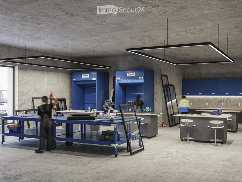 Industrial workshop with blue cabinets, workbenches, and overhead lighting.