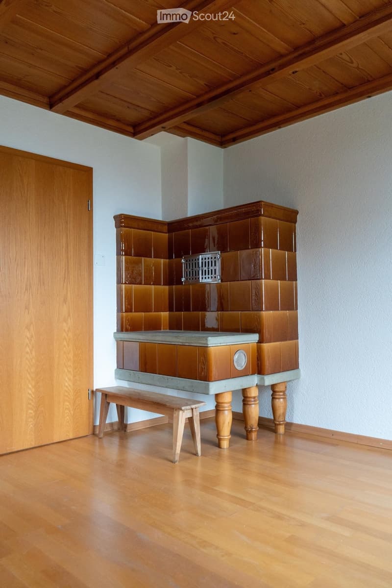 wooden floor, white wall, wooden door, bench, fireplace