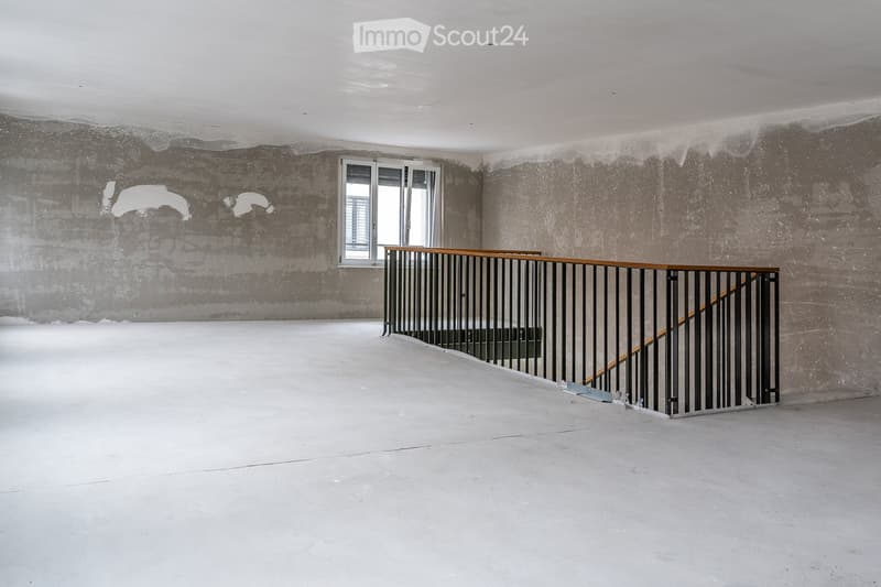 Empty room, concrete floor, concrete walls, window, staircase