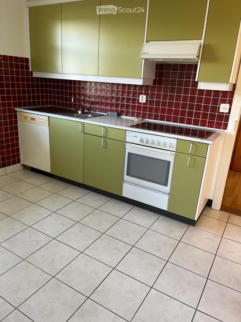 kitchen with green cabinets, white appliances, red tiles, white floor