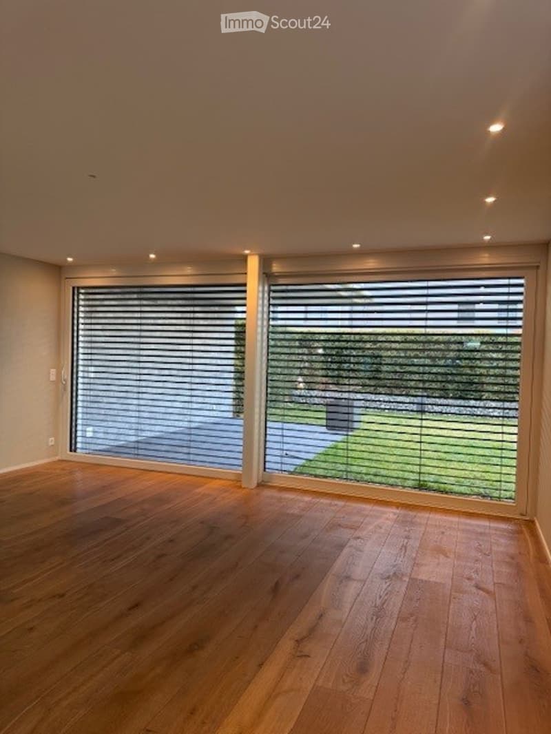 empty room, wooden floor, large windows, view of the outside