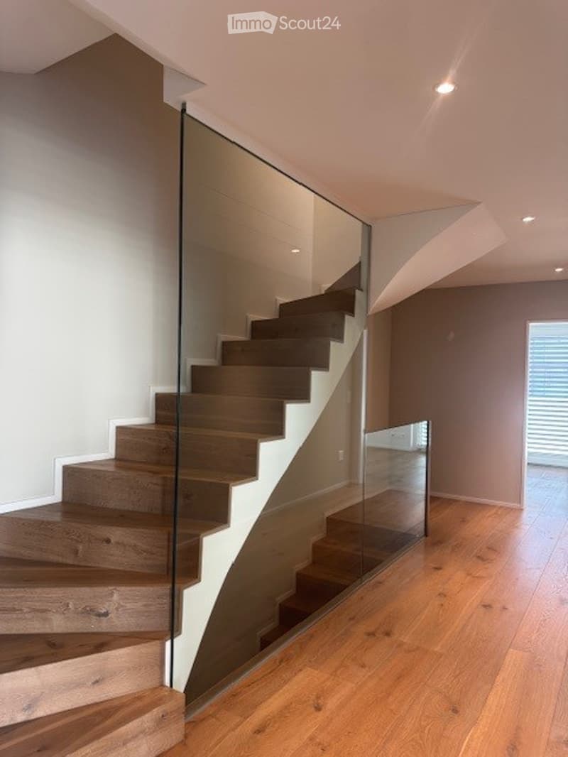 wooden stairs, glass railing, wooden floor