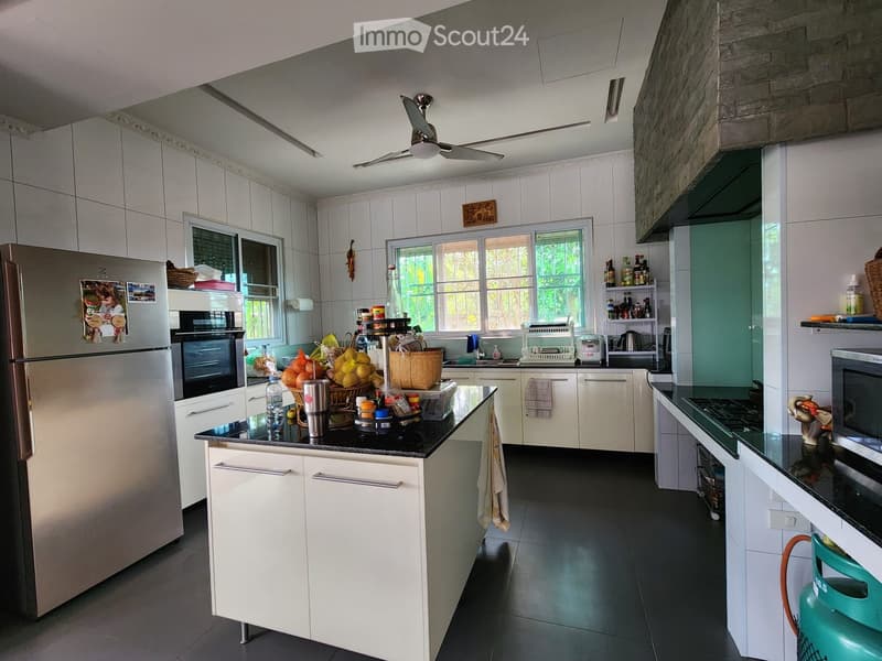 modern kitchen, white cabinets, black countertops, stainless steel appliances, ceiling fan, windows, tiled floor