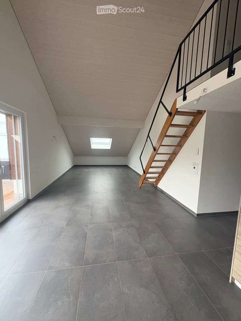 empty room, gray tiles, wooden stairs, glass door, skylight