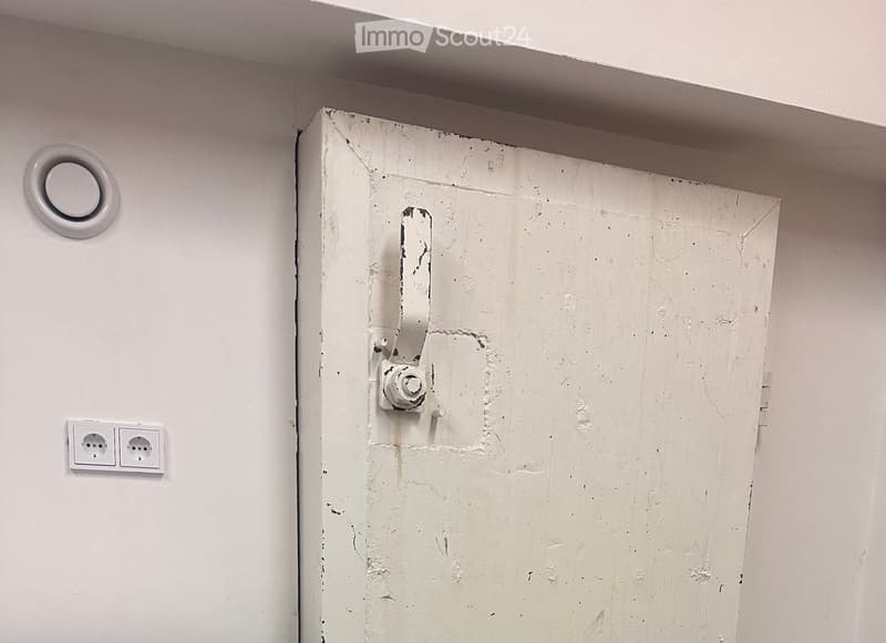 old white door with damaged paint, power outlet, exhaust fan