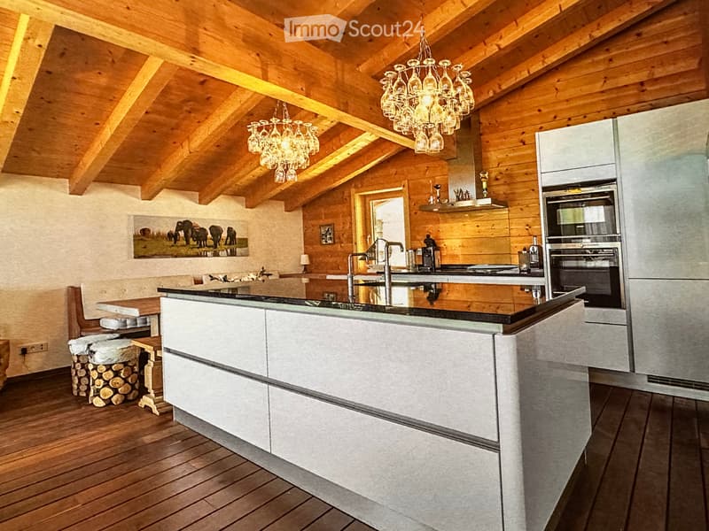 kitchen with an island, wooden planked ceiling, two chandeliers, a gas stove, a sink, a refrigerator