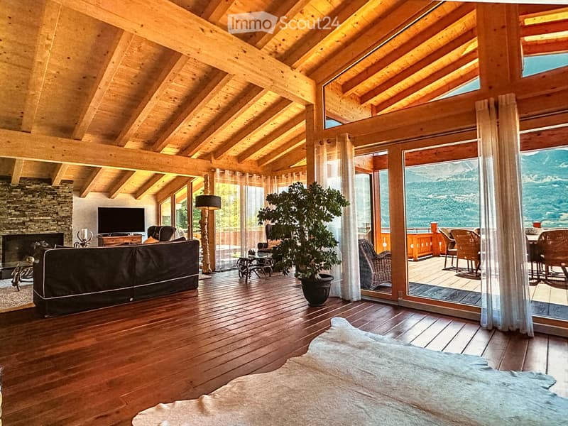 wooden ceiling, large glass windows, sofa, plant, water view