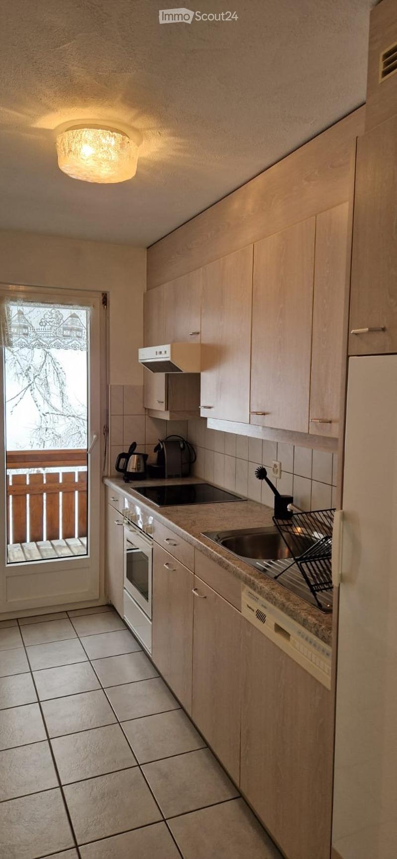 kitchen with balcony, wooden cabinets, white appliances, tiled floor