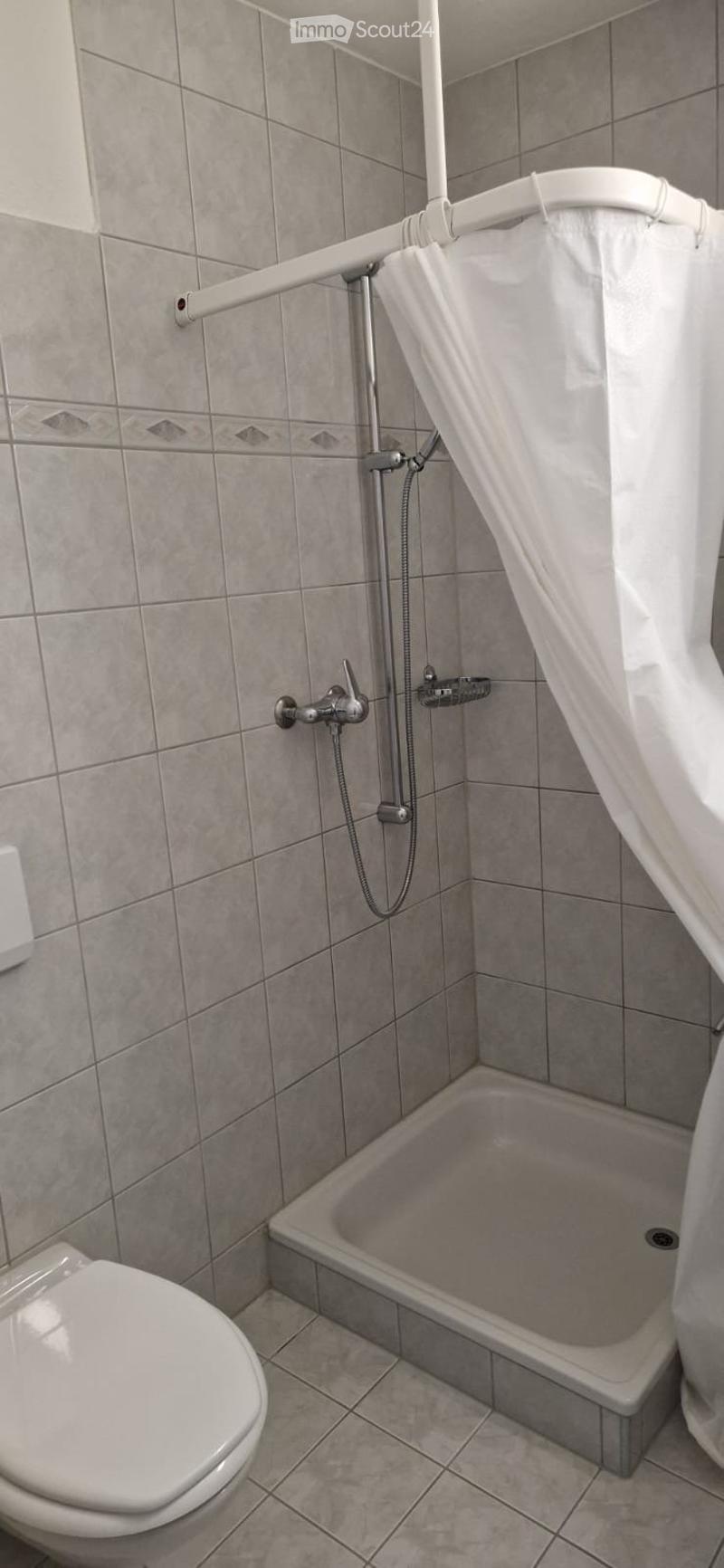 Bathroom with shower, white tiles, white toilet, white shower curtain