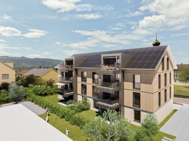 Modern multi-story residential building with balconies, solar panels on the roof, and a small garden area in front.